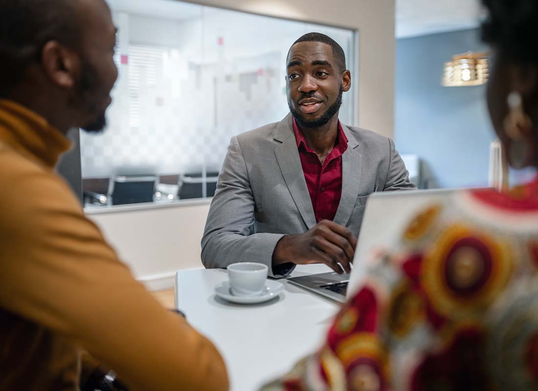 Financial Institution Insurance - Couple Meeting With a Financial Advisor and Bank Manager for Assistance at His Office in a Modern Building